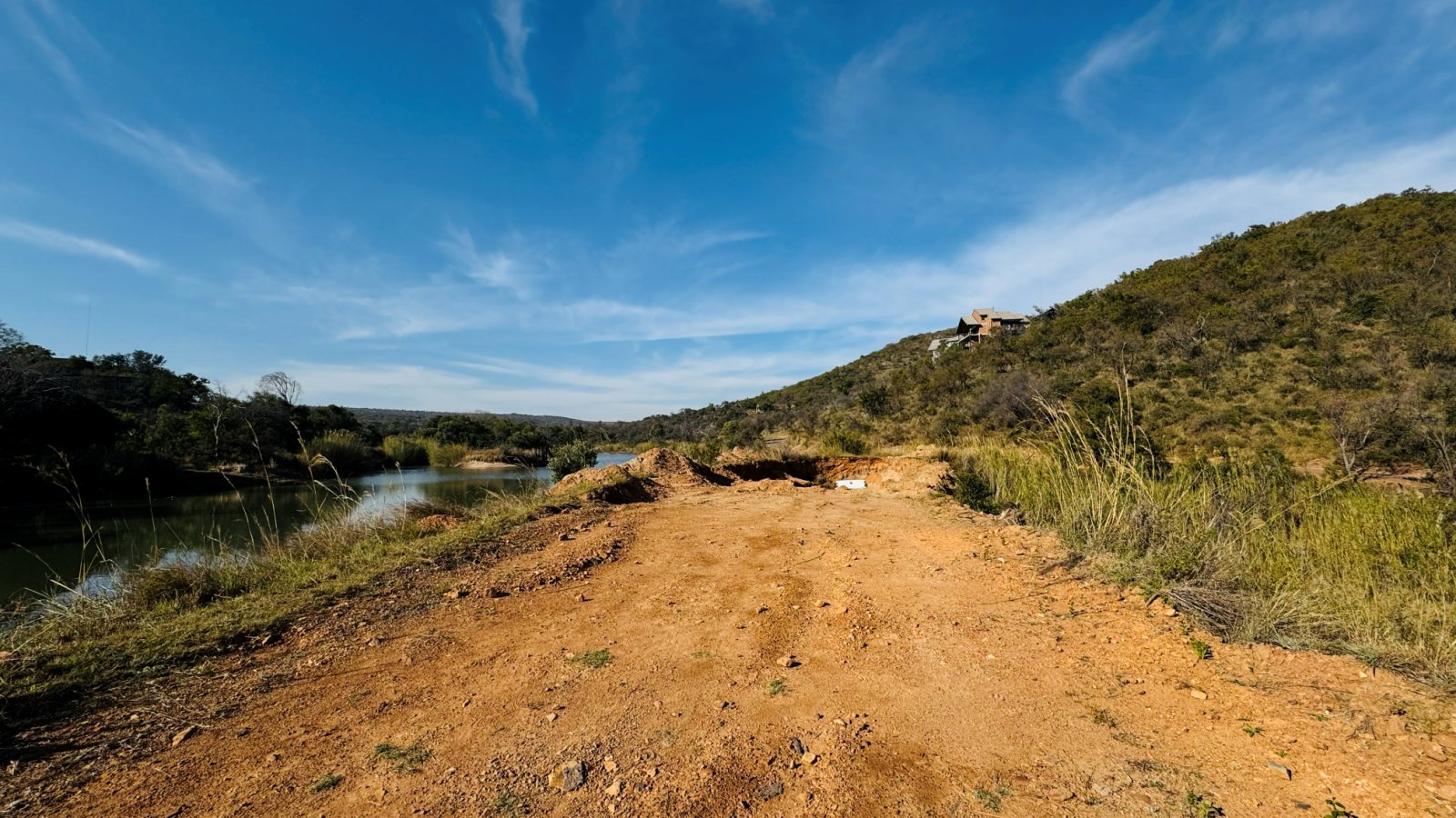 Dirt road and bushveld hills at Mabalingwe